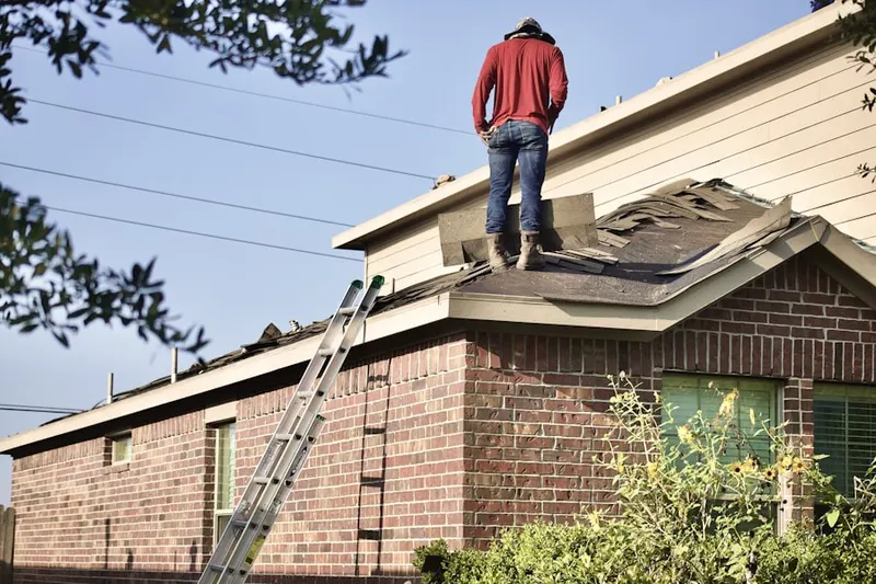 Professional roofer working on a residential roof in Carolandville
